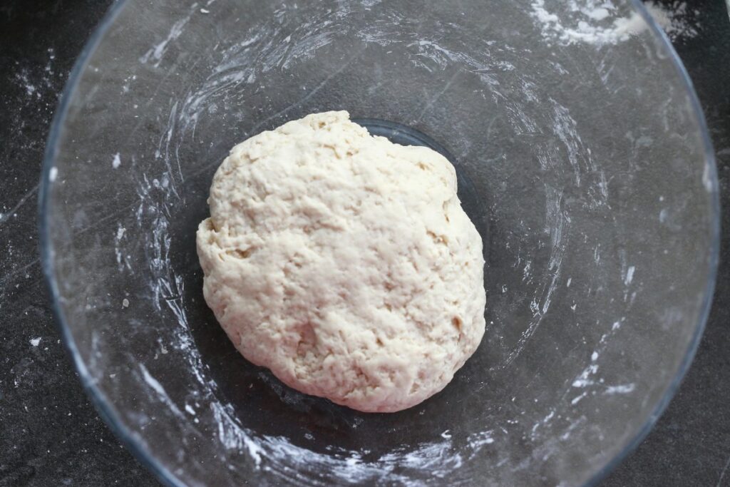 Pelmeni dough in a glass mixing bowl