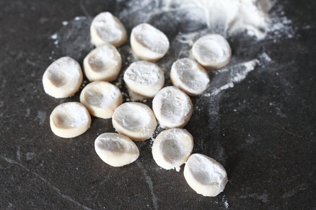 Pelmeni dough pieces dipped in flour