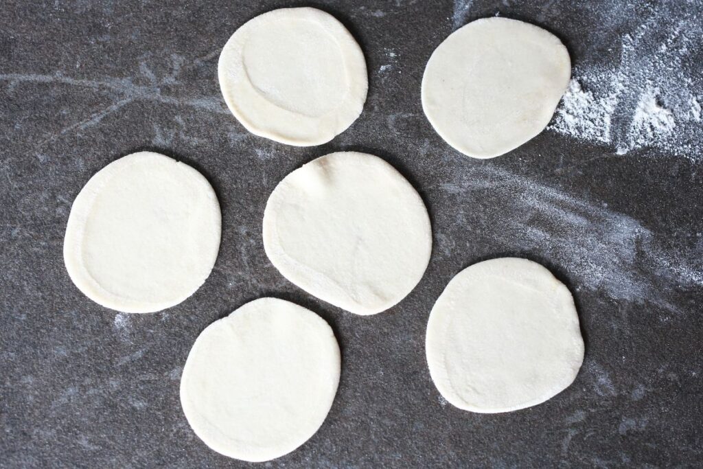 Rolled out pelmeni dough on the counter