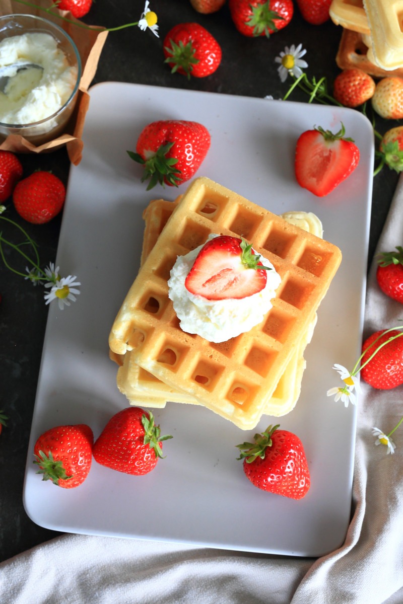 Belgian Waffles served stacked on a platter.