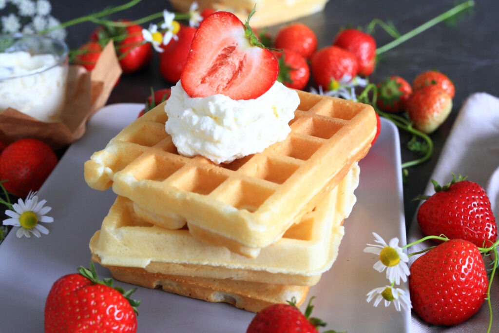 Belgian Waffles with Kefir served stacked on a platter.