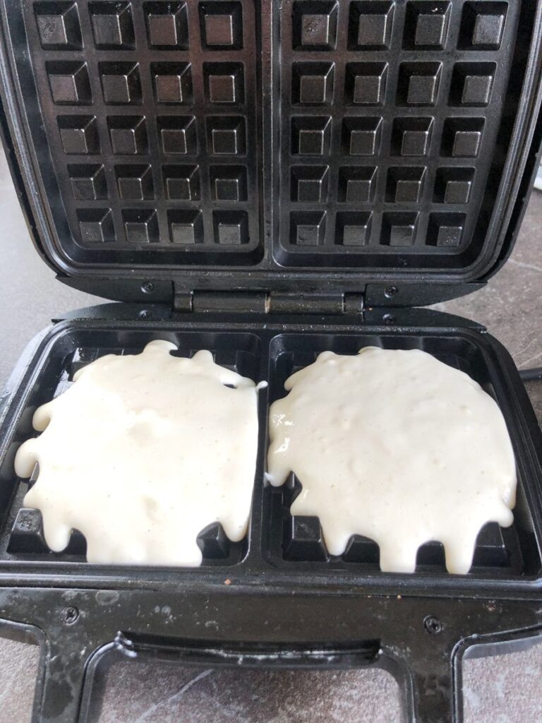 Waffle batter cooking in a waffle iron