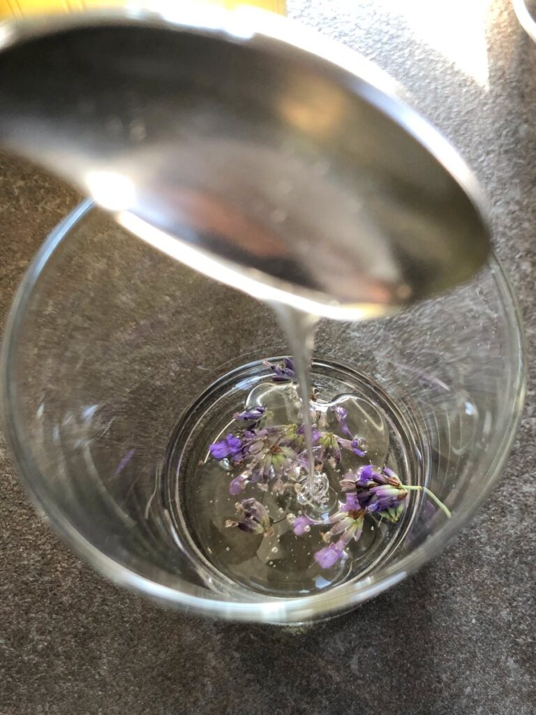 Lavender flowers mixed with honey in a glass