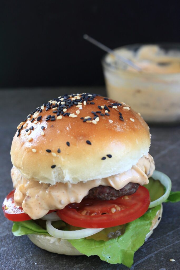 Burger Sauce served on a burger with extra sauce in a bowl.