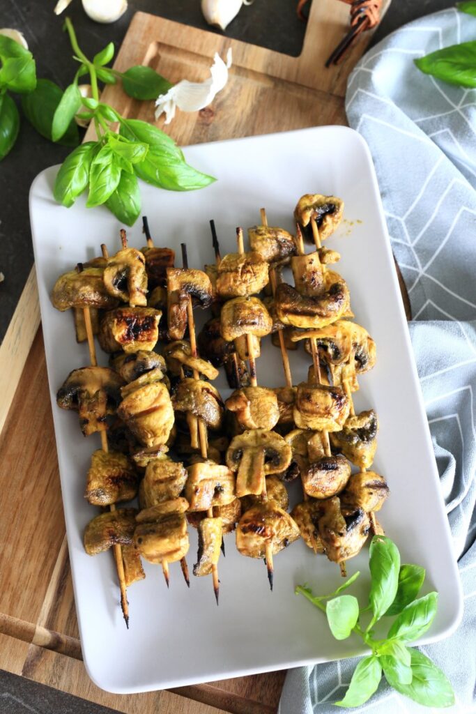 Grilled Mushrooms on skewers served on a platter