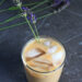 Honey Lavender Cold Brew coffee served in a glass with sprigs of lavender.