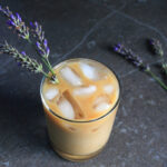 Honey Lavender Cold Brew coffee served in a glass with sprigs of lavender.