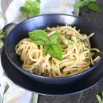 Zucchini pasta with Gouda served in a charcoal bowl.