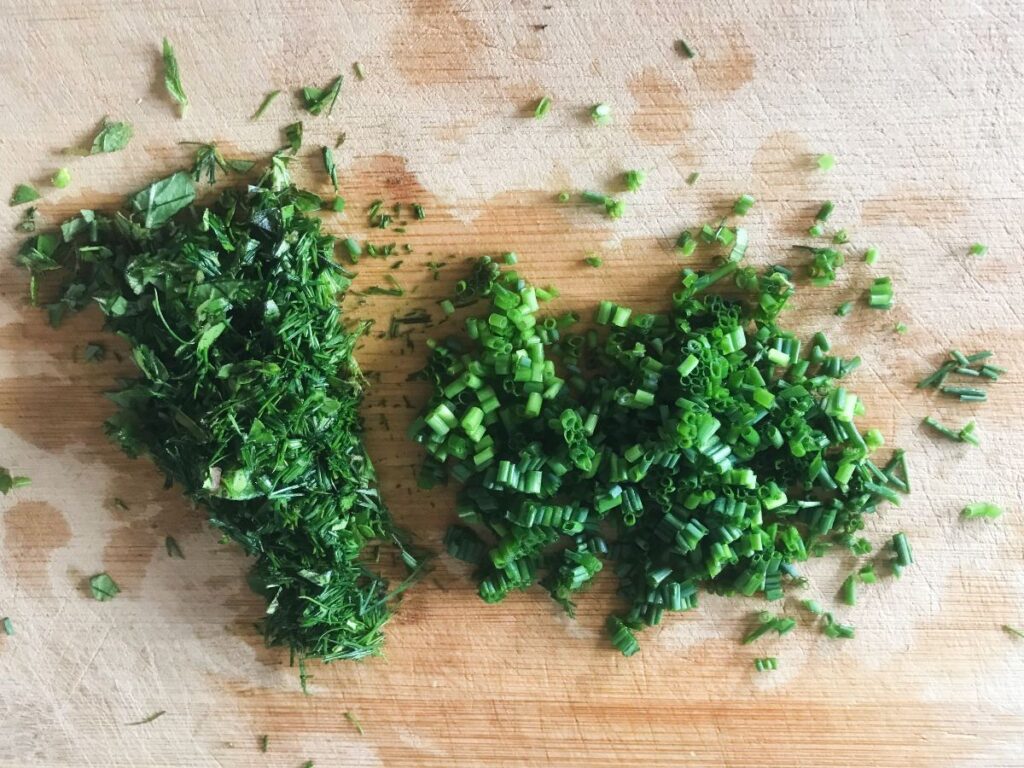 Chopped green herbs on a cutting board