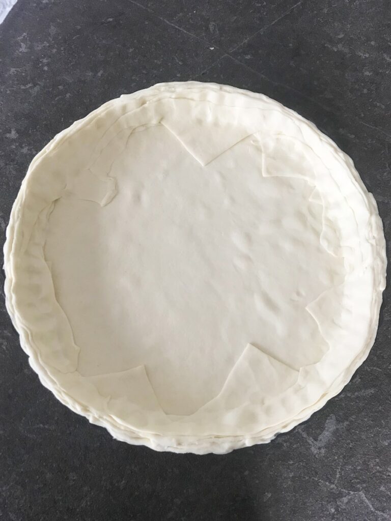 Puff pastry dough crust in a tart pan