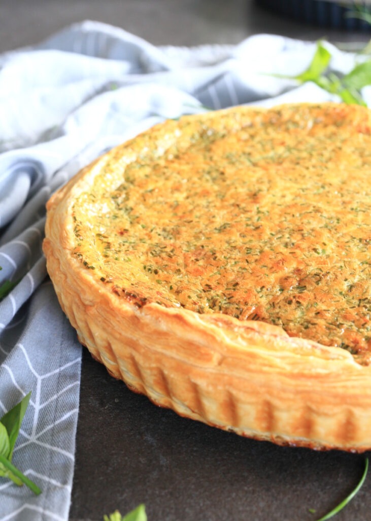 Lazy Quiche Lorraine on a table surrounded by a kitchen towel.