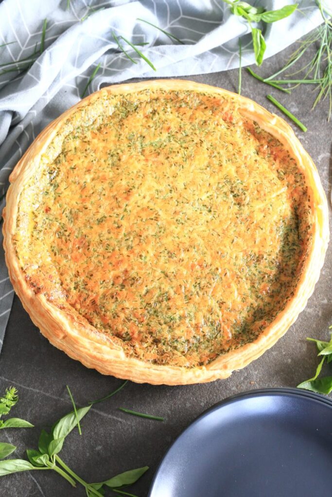 Lazy Quiche Lorraine on a table surrounded by a kitchen towel.