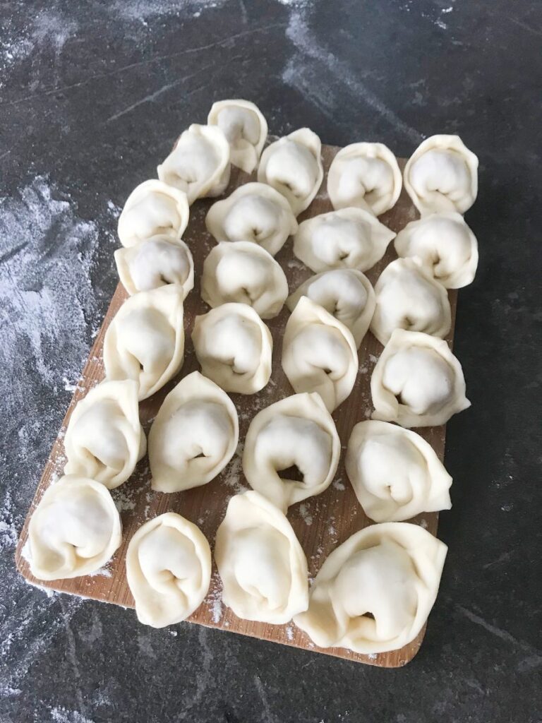 Finished pelmeni on a cutting board