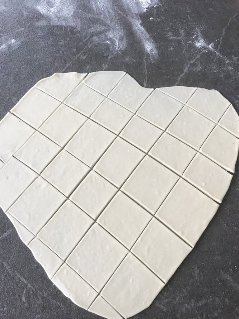 Rolled out dough cut into squares