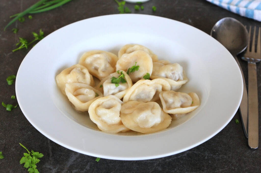 Pelmeni meat dumplings served in a bowl