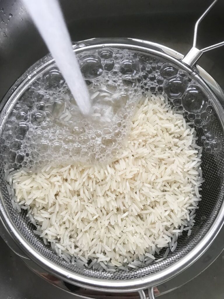 washing basmati rice in a sieve