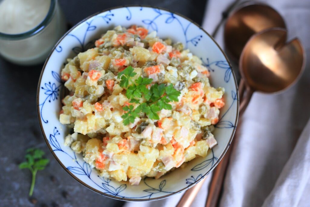 Olivye Russian Potato Salad served in a bowl.