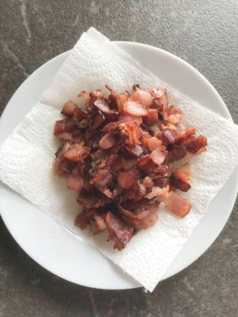 Fried bacon pieces on paper toweled plate