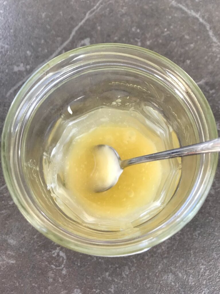 Mayo and honey mixed together in a jar.