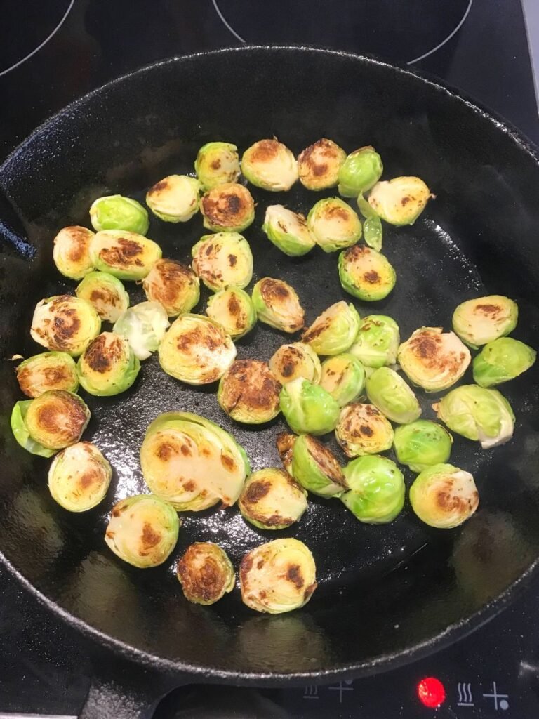 Seared brussels sprouts in a cast iron skillet