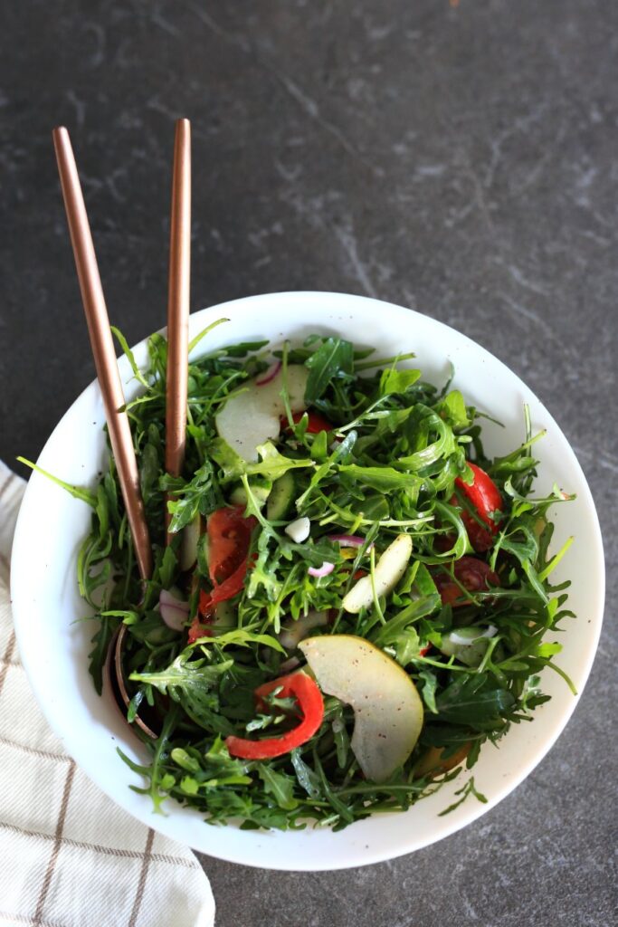 Arugula Pear Salad served in a bowl