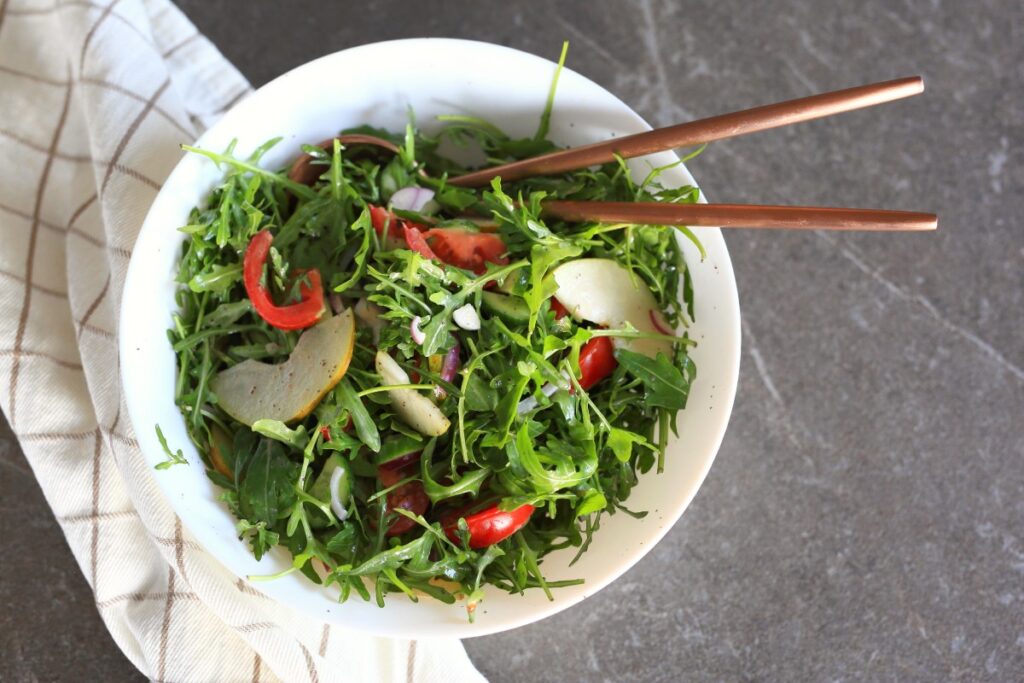 Arugula Pear Salad served in a bowl