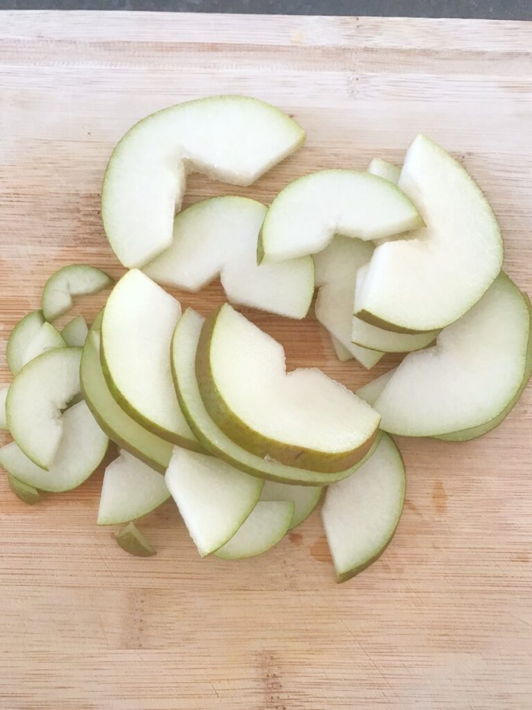 Sliced pear on a bamboo cutting board