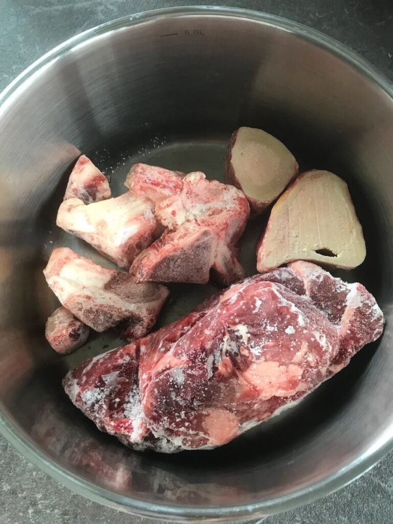 Beef meat and bones for bone broth in a pot