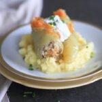 Stuffed peppers served with sour cream on a plate