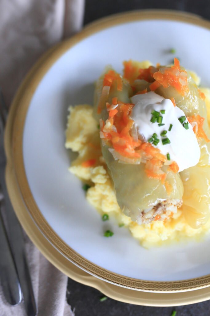 Stuffed peppers served with sour cream on a plate