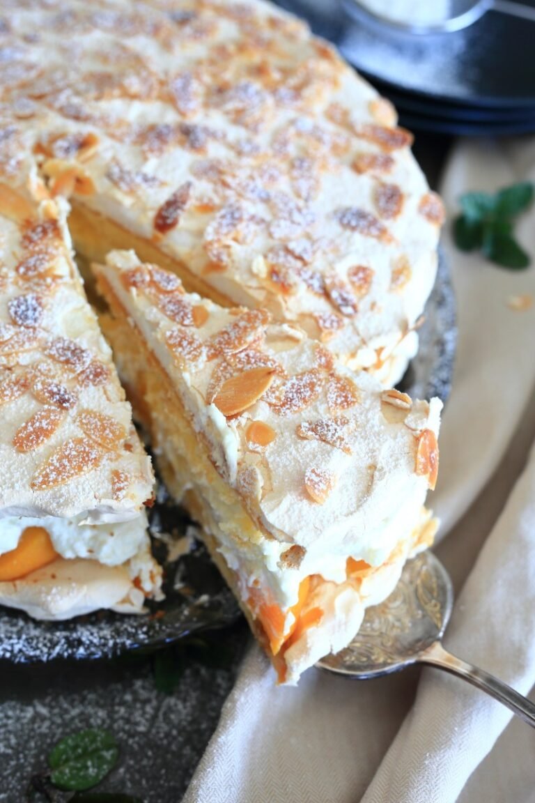 Peach Meringue cake served on a platter.