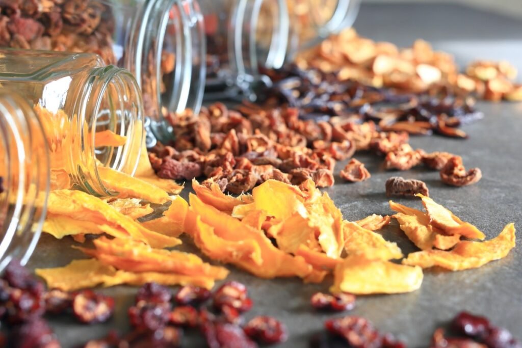 Dried fruit snacks spilling from glass jars