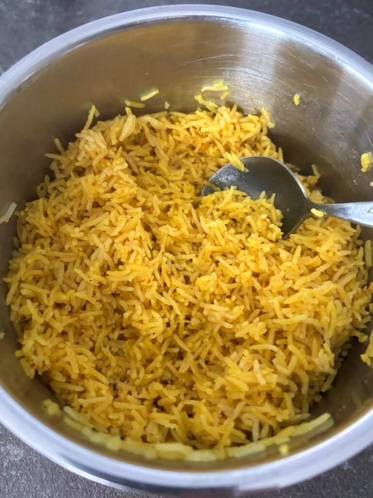 Cooked spiced rice in a saucepan.