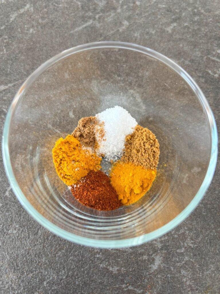Measured out spices in a small mixing bowl.