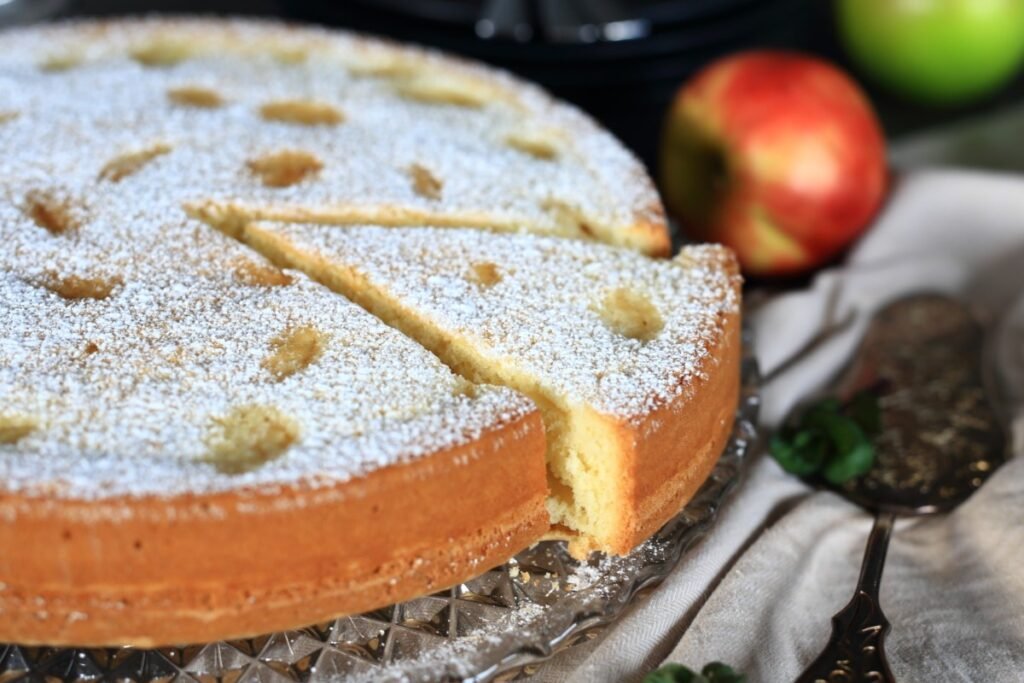 Sponge cake with apples on a platter