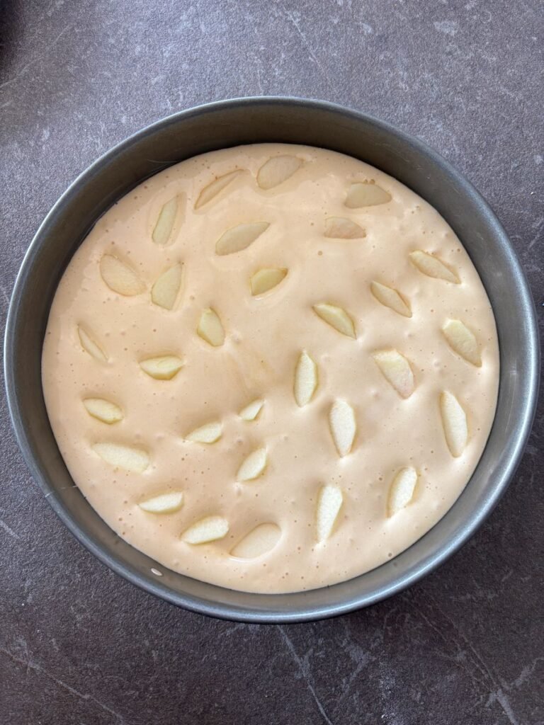 Cake batter with apples in springform pan