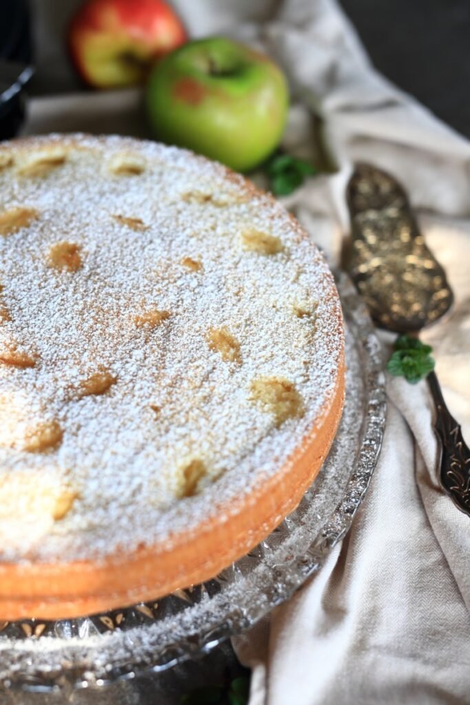 Sponge cake with apples on a platter