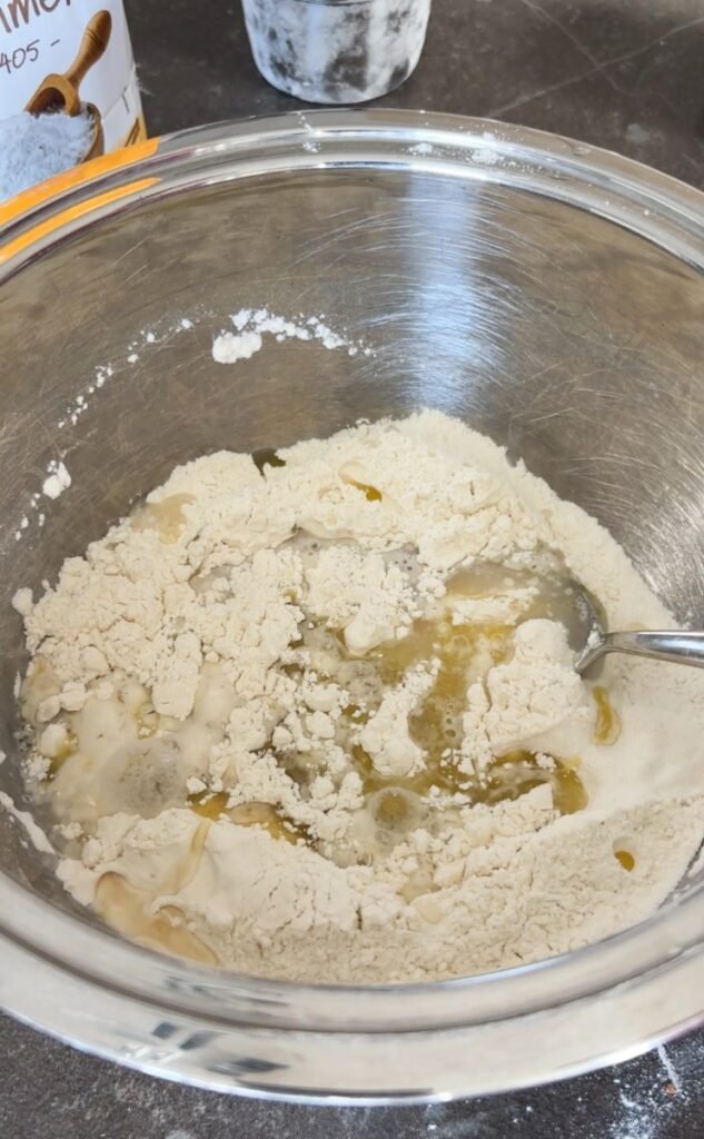 Ingredients for Flammkuchen dough in a mixing bowl