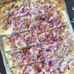 Flammkuchen served on a cutting board