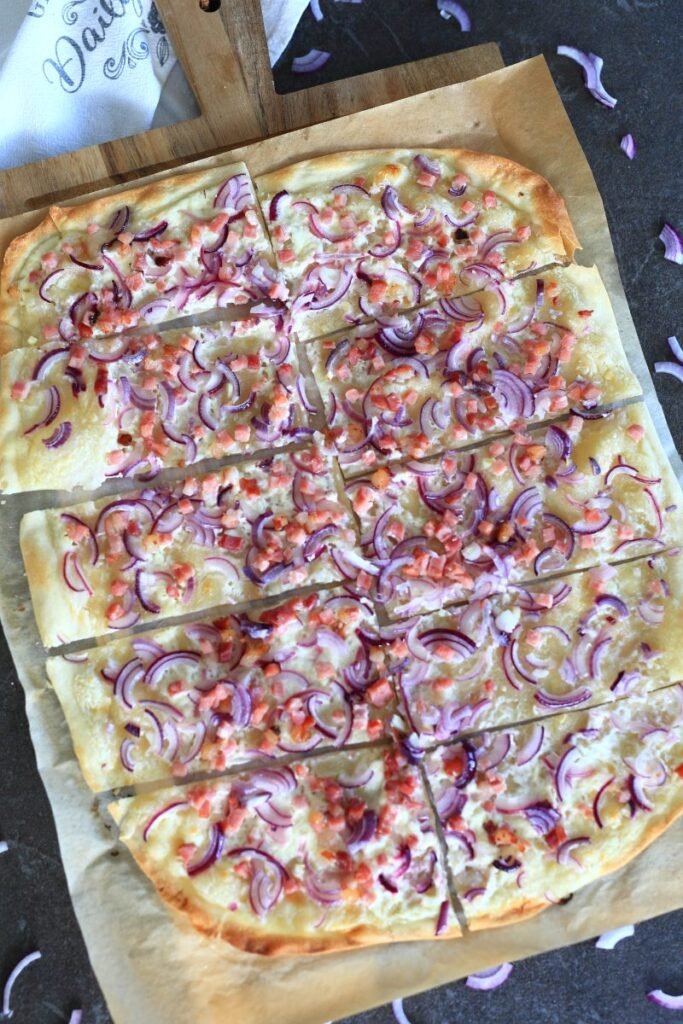 Flammkuchen served on a cutting board