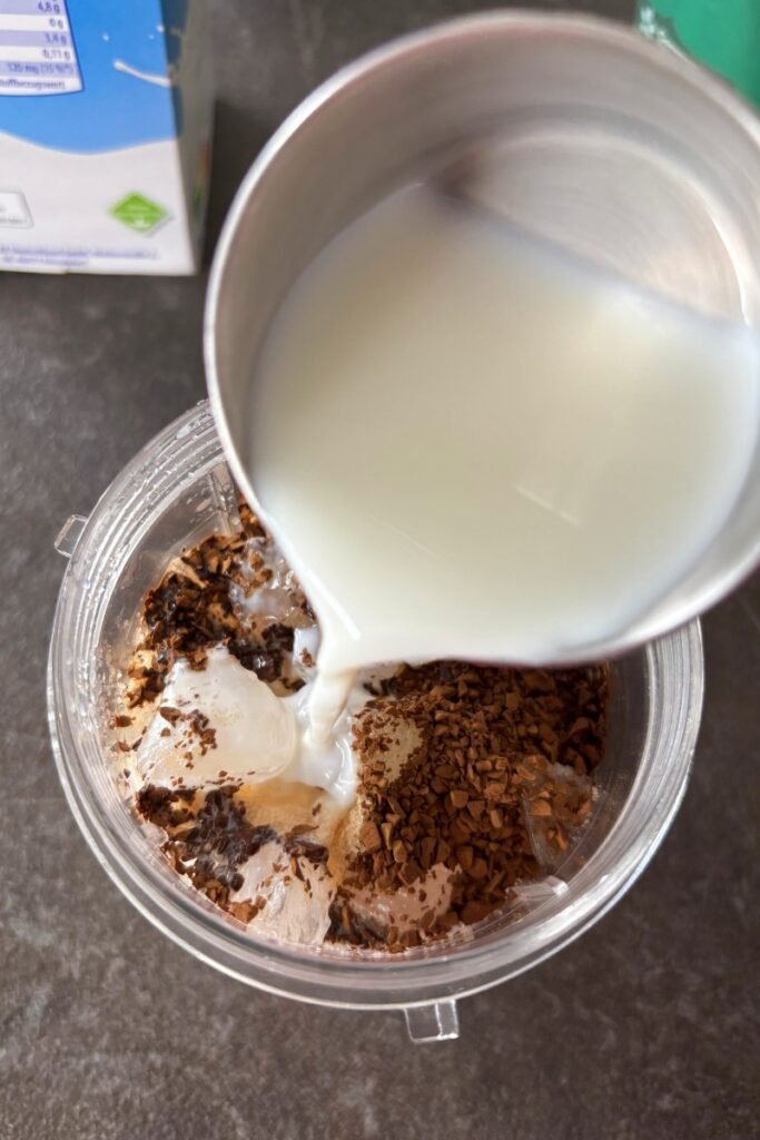 Adding milk to ice and coffee
