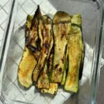 Grilled zucchini slices served in a glass dish
