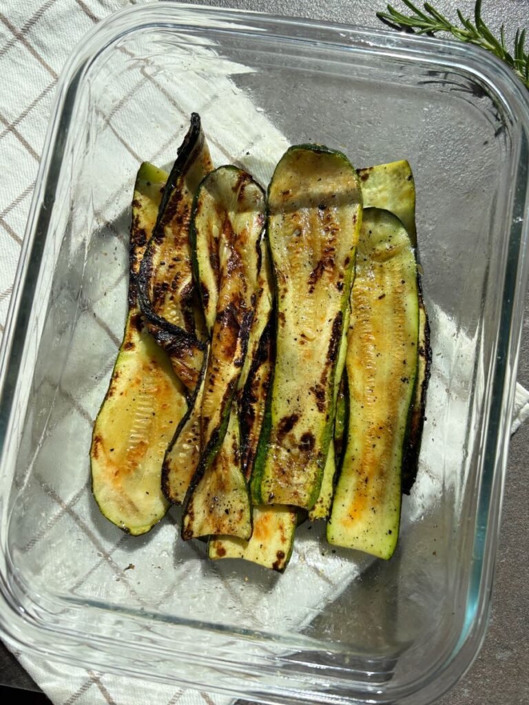 Grilled zucchini slices served in a glass dish