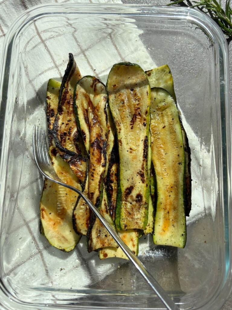 Grilled zucchini slices served in a glass dish