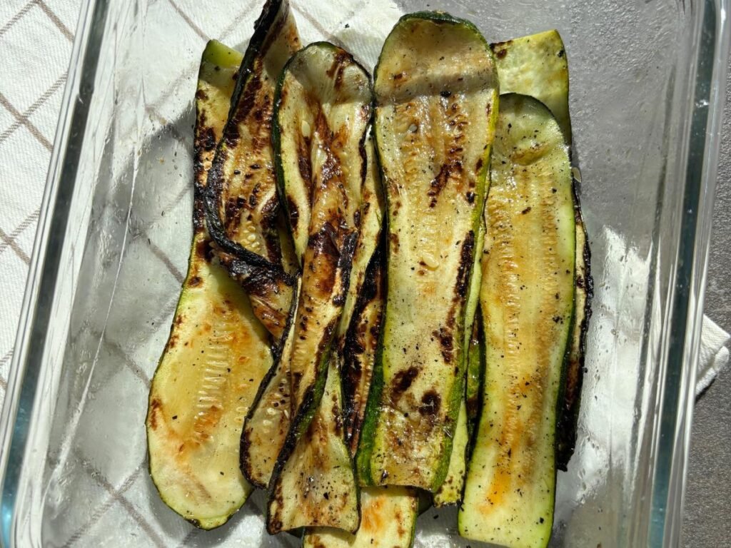 Grilled zucchini slices served in a glass dish